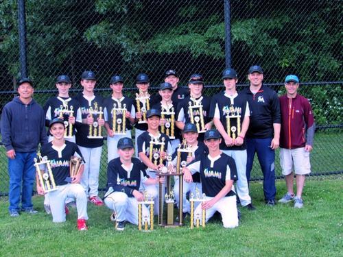 Reading Marlins players and coaches pose with their championship trophies after defeating the Mariners in Game 3 of the RBRL World Series.