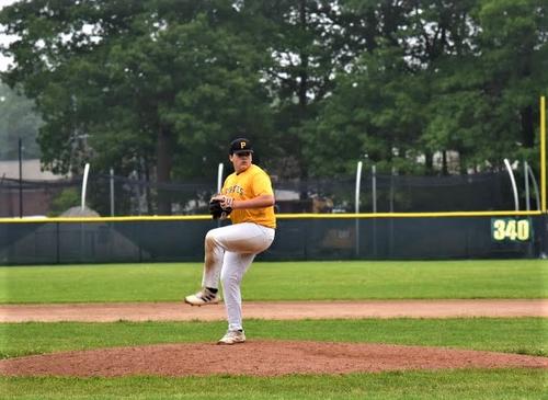 A Reading Pirates pitcher in gold and black leg-kicks during Game 1 of the 2023 RBRL World Series at Pete Moscariello Ballpark.