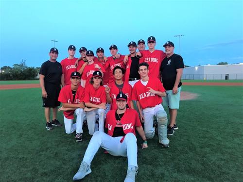 The Reading Summer Rockets pose for a team photo at dusk after winning the Senior Babe Ruth tournament.